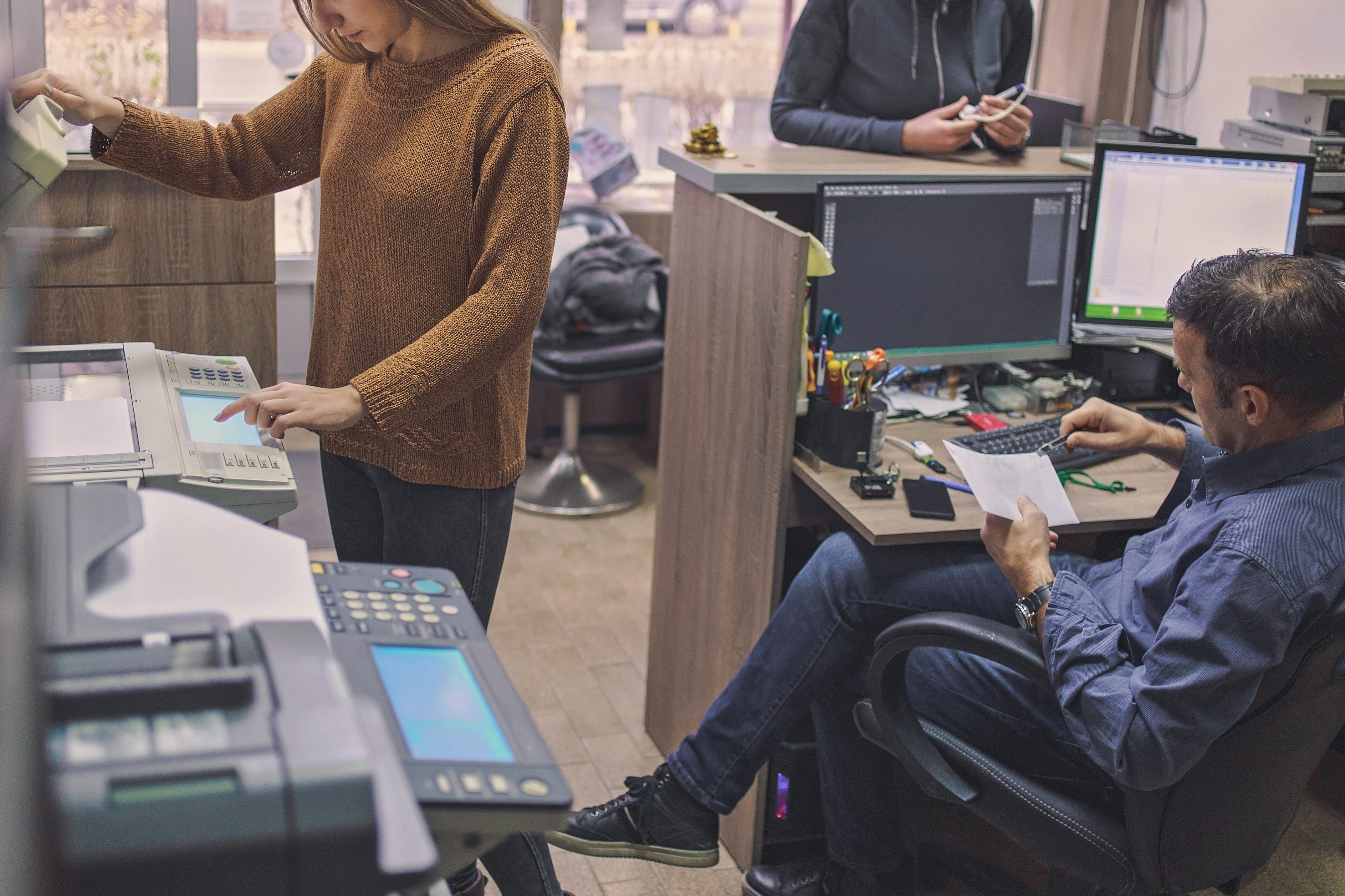 A woman and a man working in a printing center
