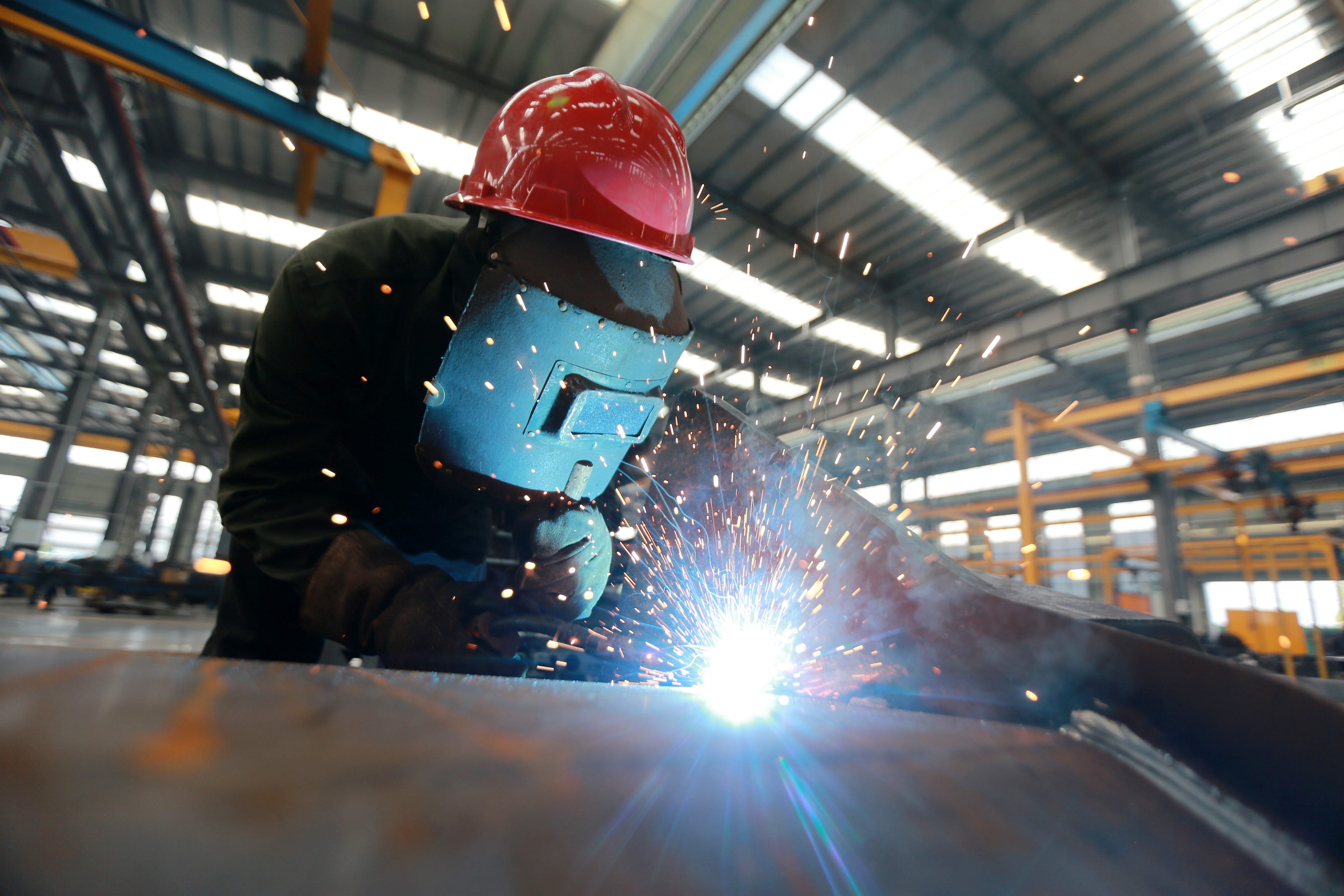 A worker carries out welding operations at the workshop of a machinery manufacturing enterprise on June 13, 2025 in Yangzhou, Jiangsu Province of China.