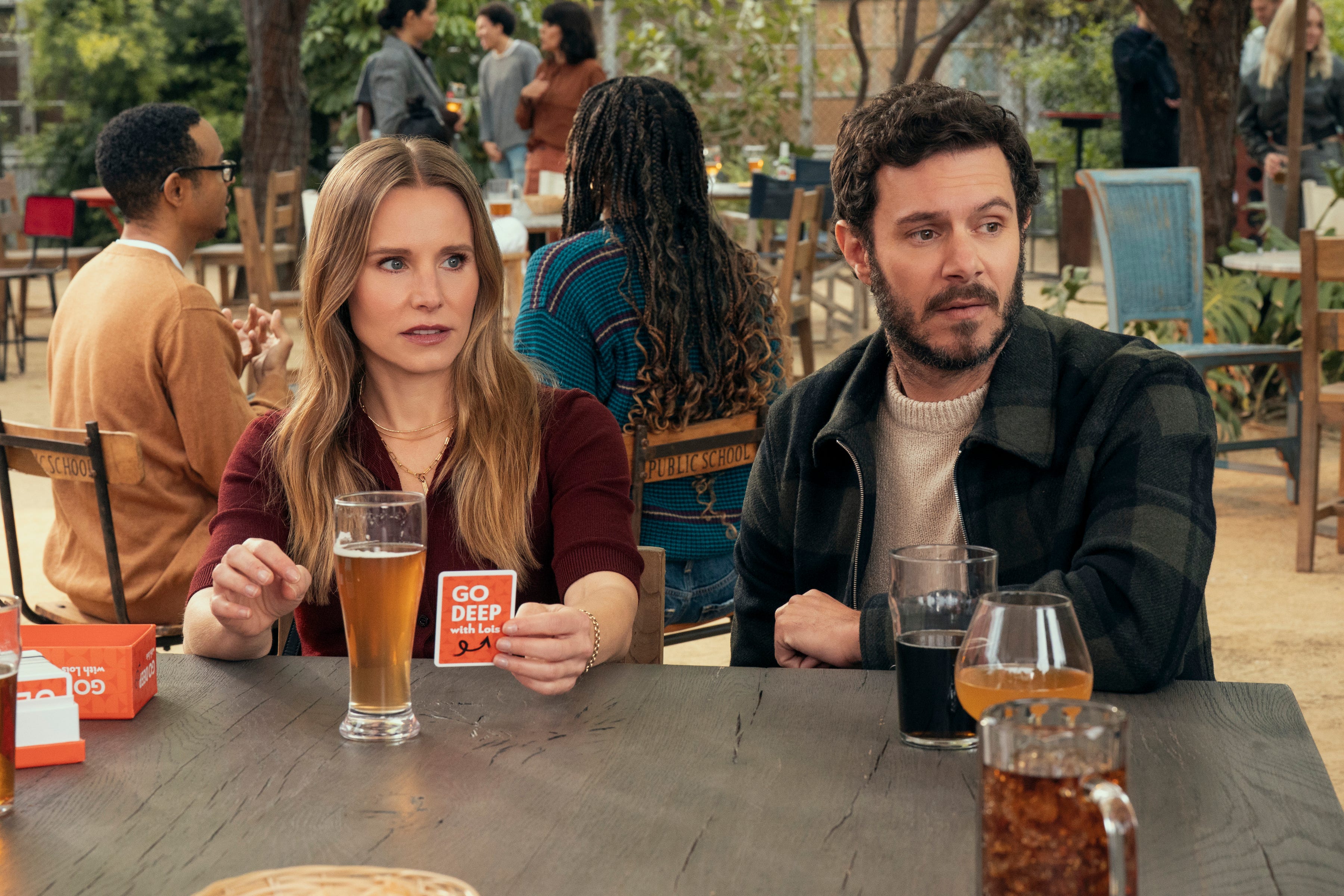 Kristen Bell and Adam Brody at a table in Nobody Wants This