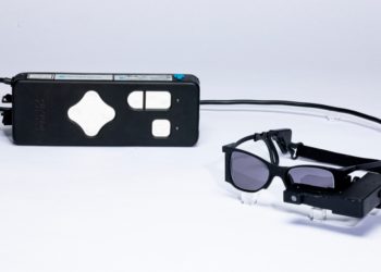 With a tiny eye implant and special glasses, some legally blind patients can read again