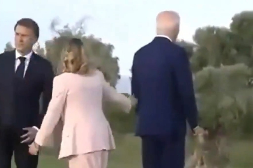 Italian Prime Minister Giorgia Meloni grabs President Joe Biden during a G7 summit in Italy on July 13, 2024.
