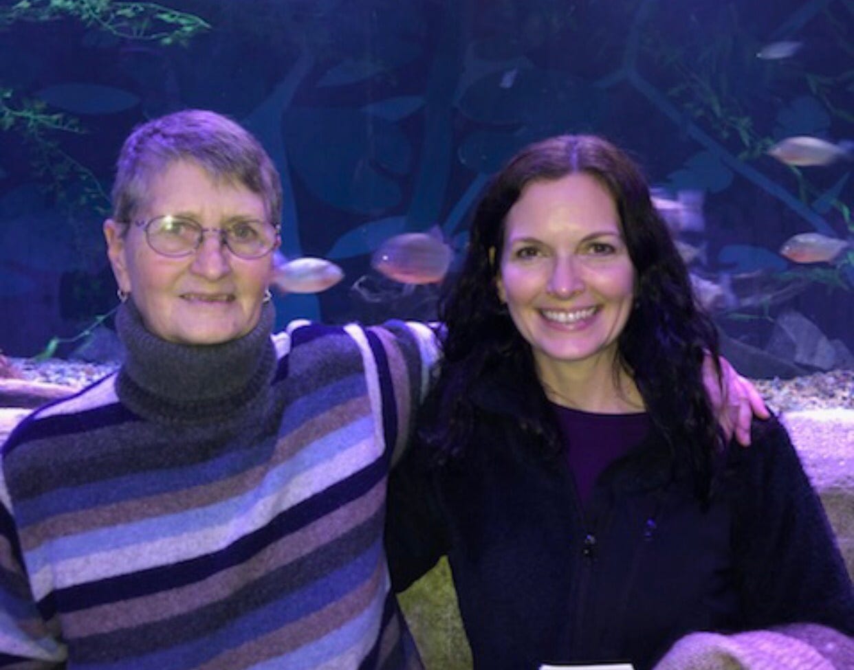The author and her mother in front of a fish tank in 2020.