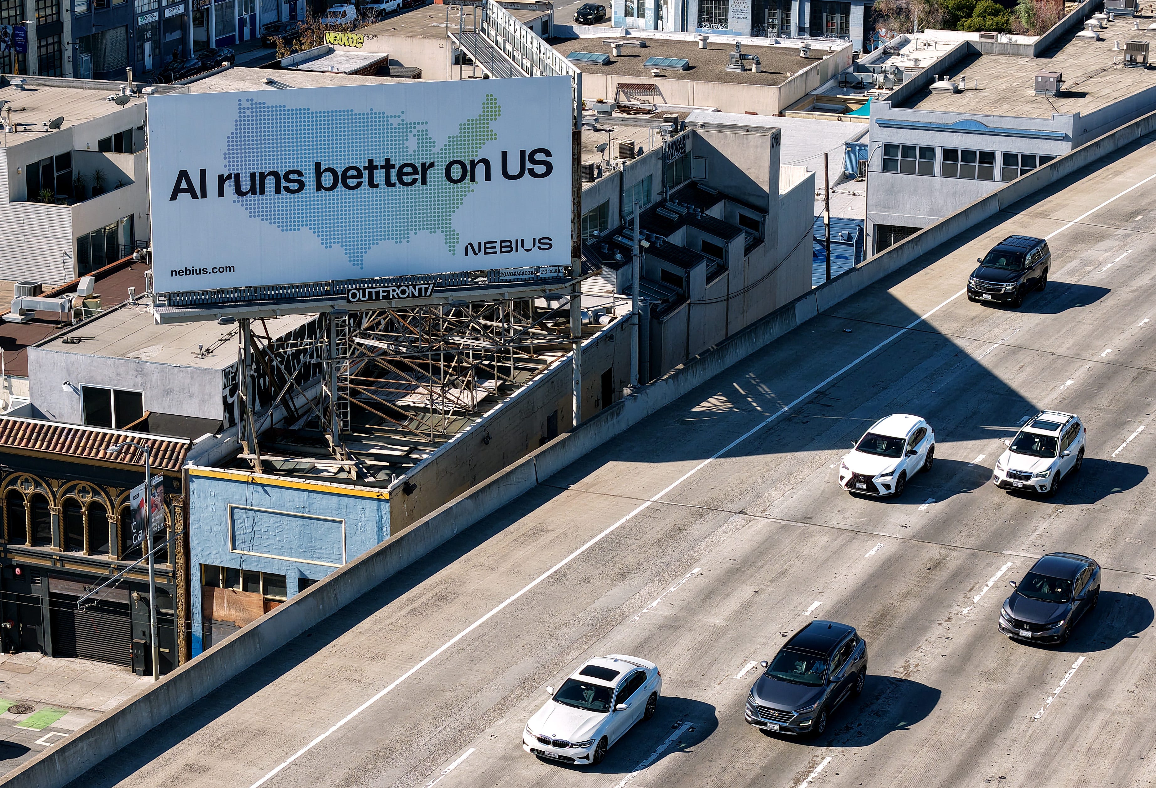 SAN FRANCISCO, CALIFORNIA - SEPTEMBER 16: In an aerial view, a billboard advertising an artificial intelligence (AI) company is posted on September 16, 2025 i