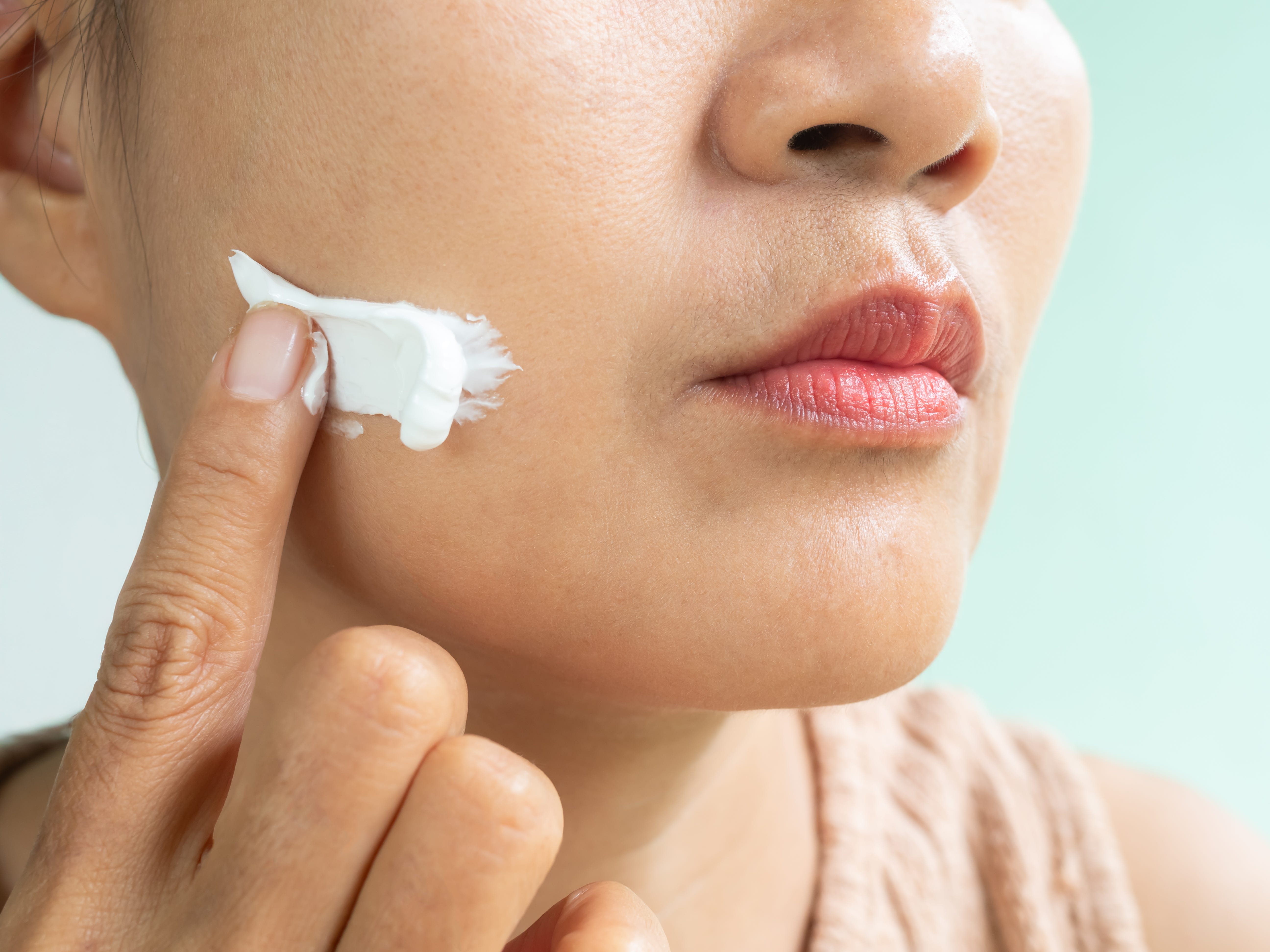 woman applying sunscreen.
