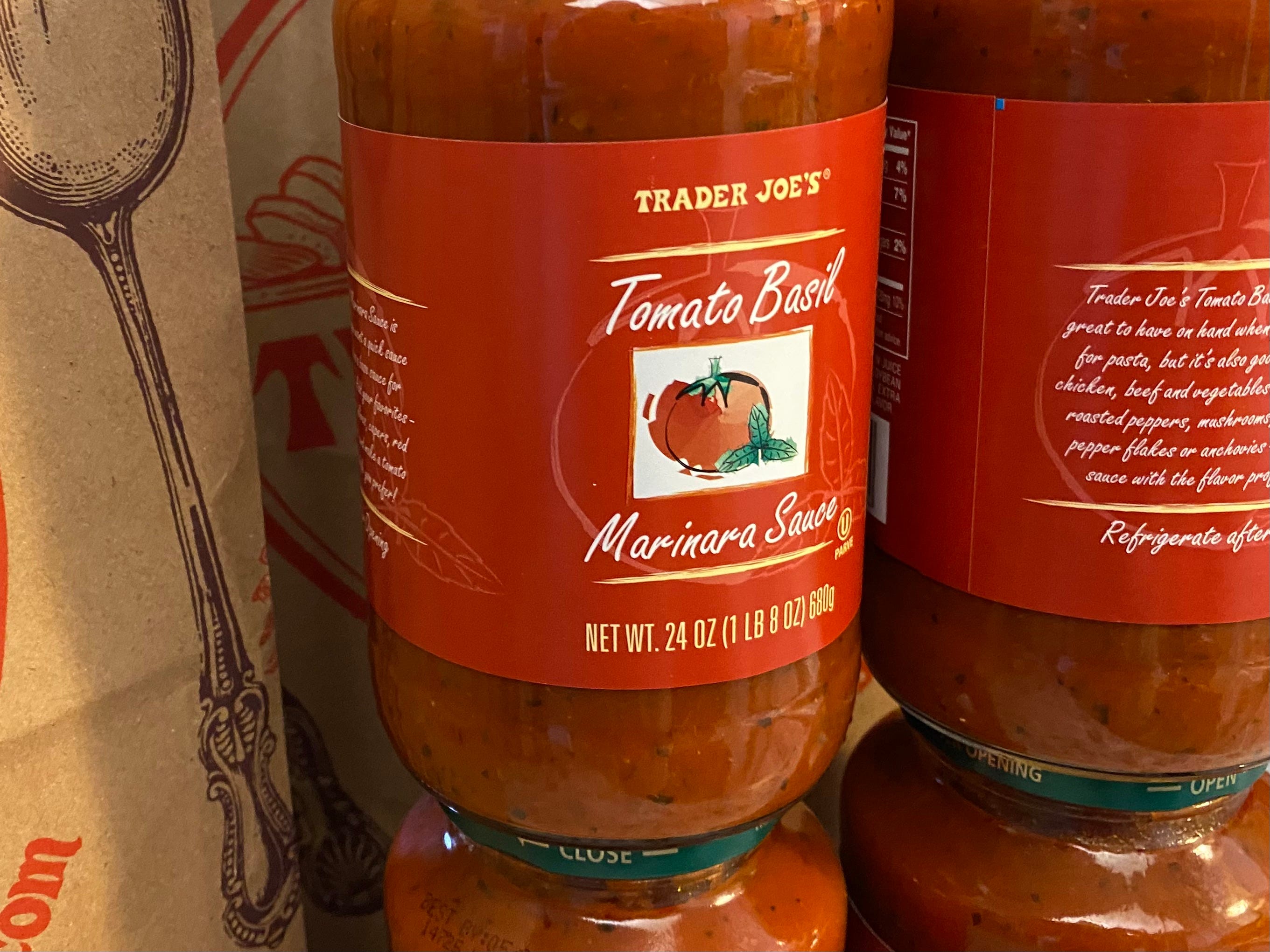 A close-up on a jar of Trader Joe's tomato basil mariana sauce.