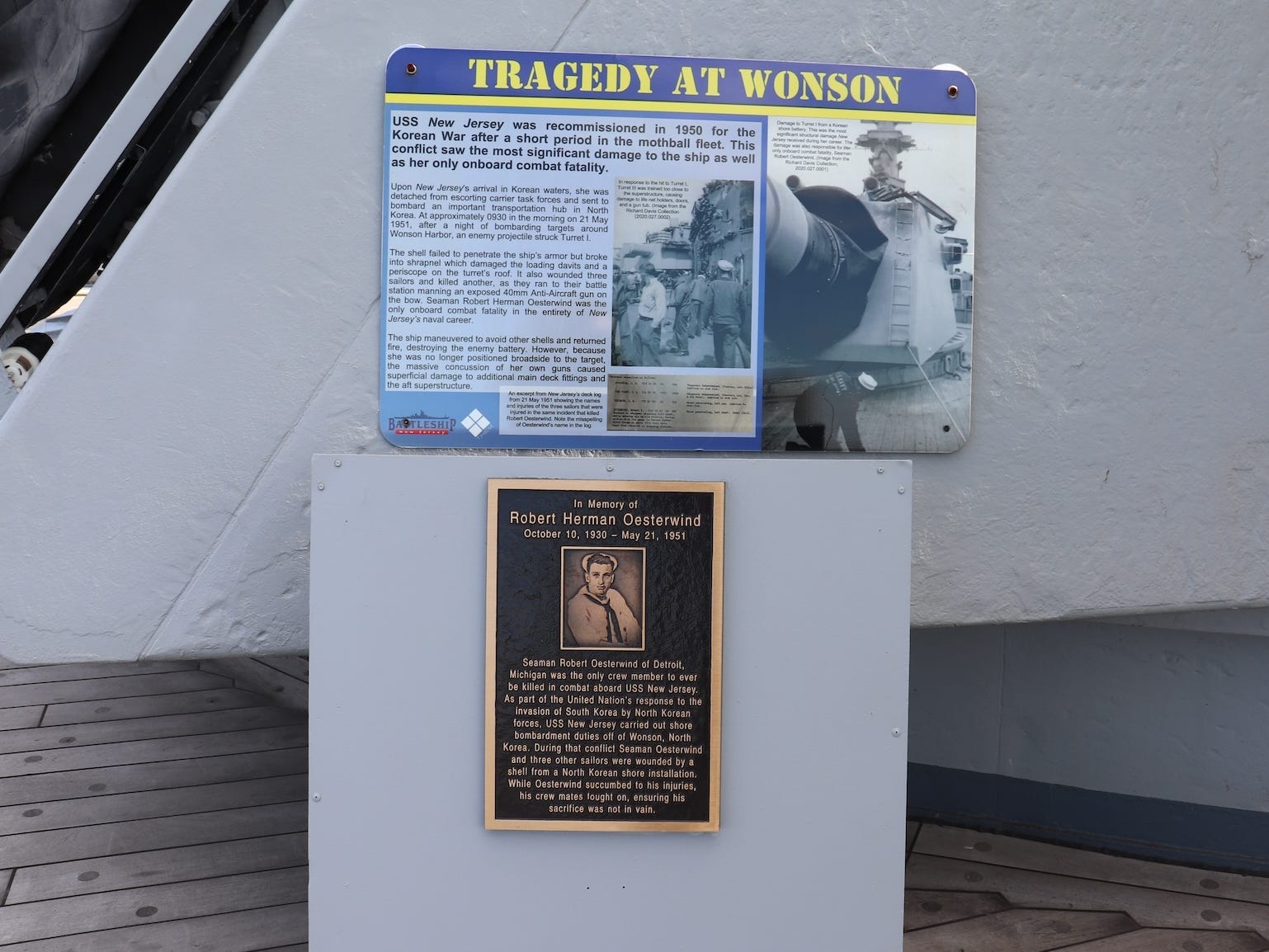 A plaque memorializing a fallen crew member of the USS Ner Jersey.
