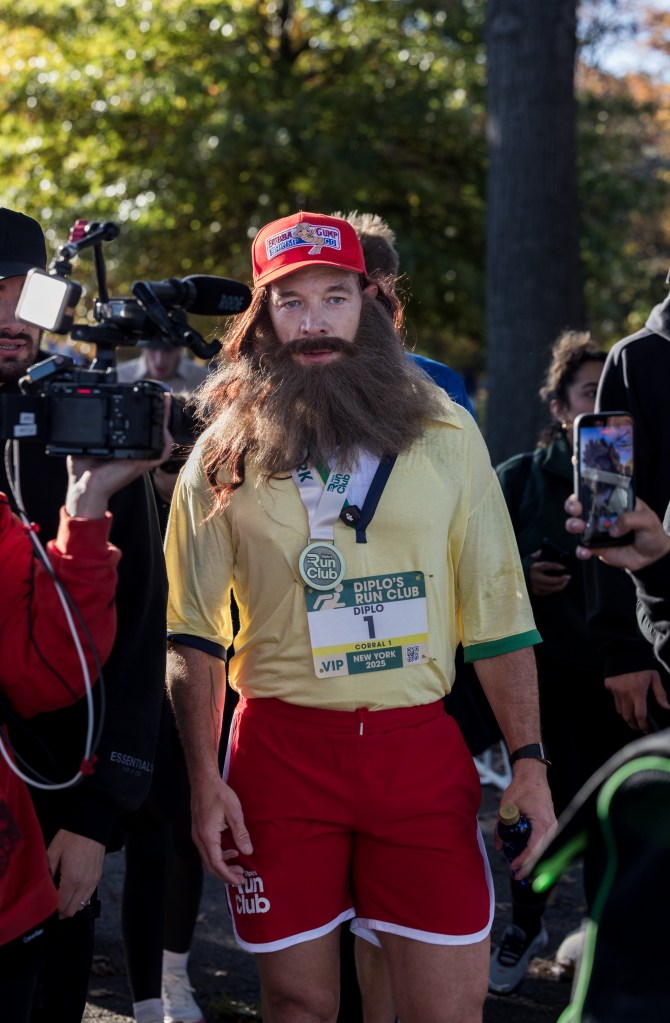 Diplo leads the way with his running club while dressed as Forrest Gump for a Halloween week run in Queens.