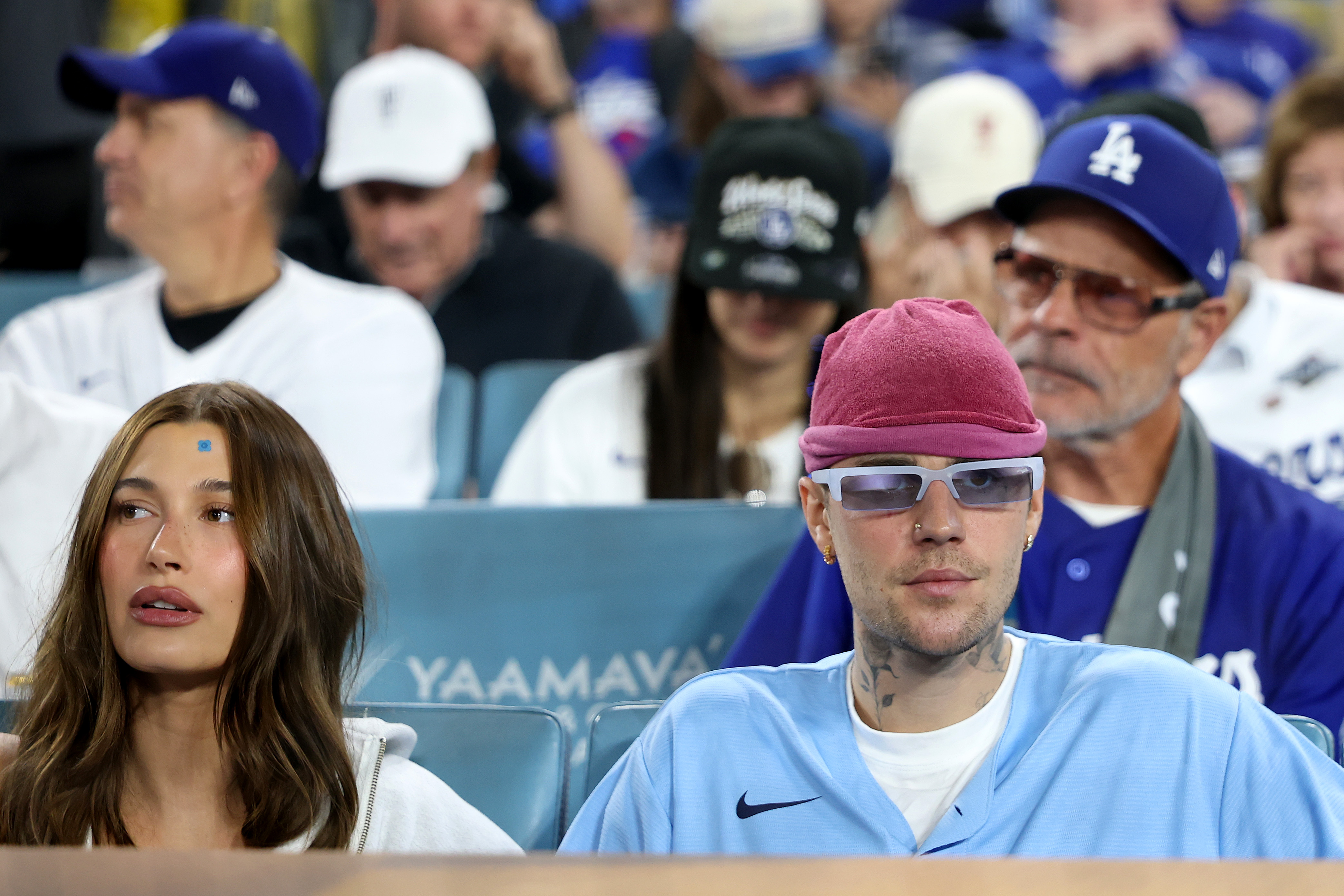 On a date night, Hailey (wearing a pimple patch) and Justin Bieber (in a Blue Jays jersey) take in Game 3 of the World Series at Dodger Stadium.
