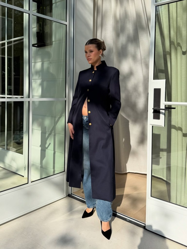 Sofia Richie shows off her baby bump in a Tommy Hilfiger coat at the  Vogue World event in LA.