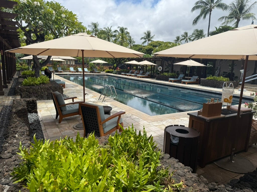 Lap pool with umbrellas, chairs around it