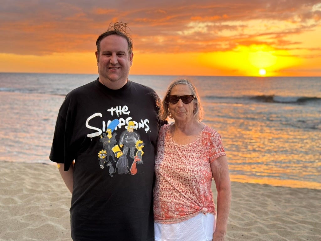 Author David Morris with woman in front of sunset at Hawaii