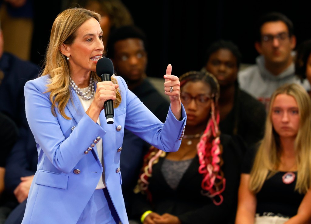 Mikie Sherrill speaking into a microphone, gesturing with her right hand, during a debate.