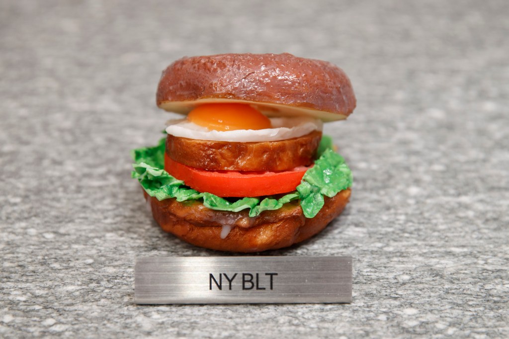 Illustration of an NY BLT donut on a gray speckled surface from I’m donut ?