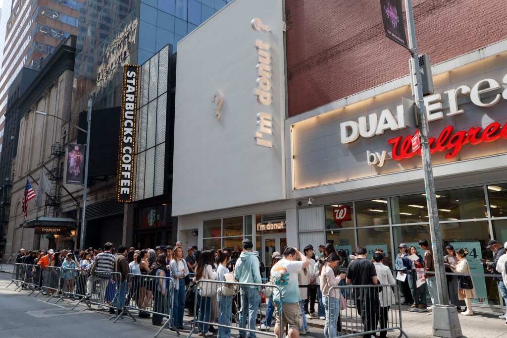 People waiting in a long line outside 