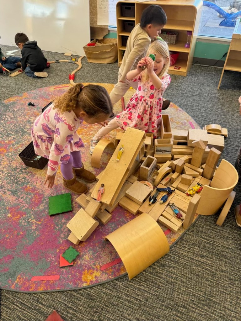 Children play with blocks and toys at a daycare.