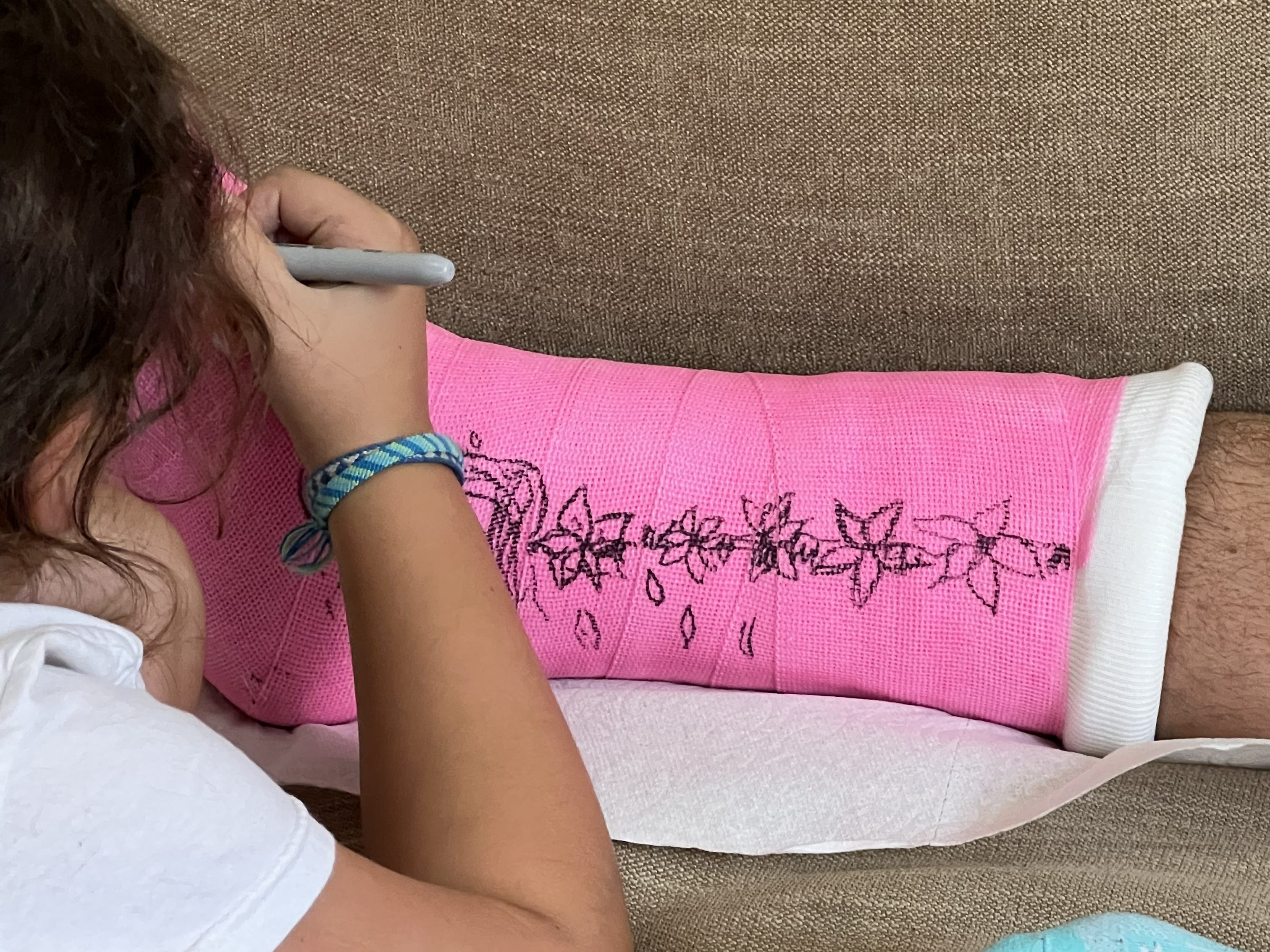 Child drawing on leg cast