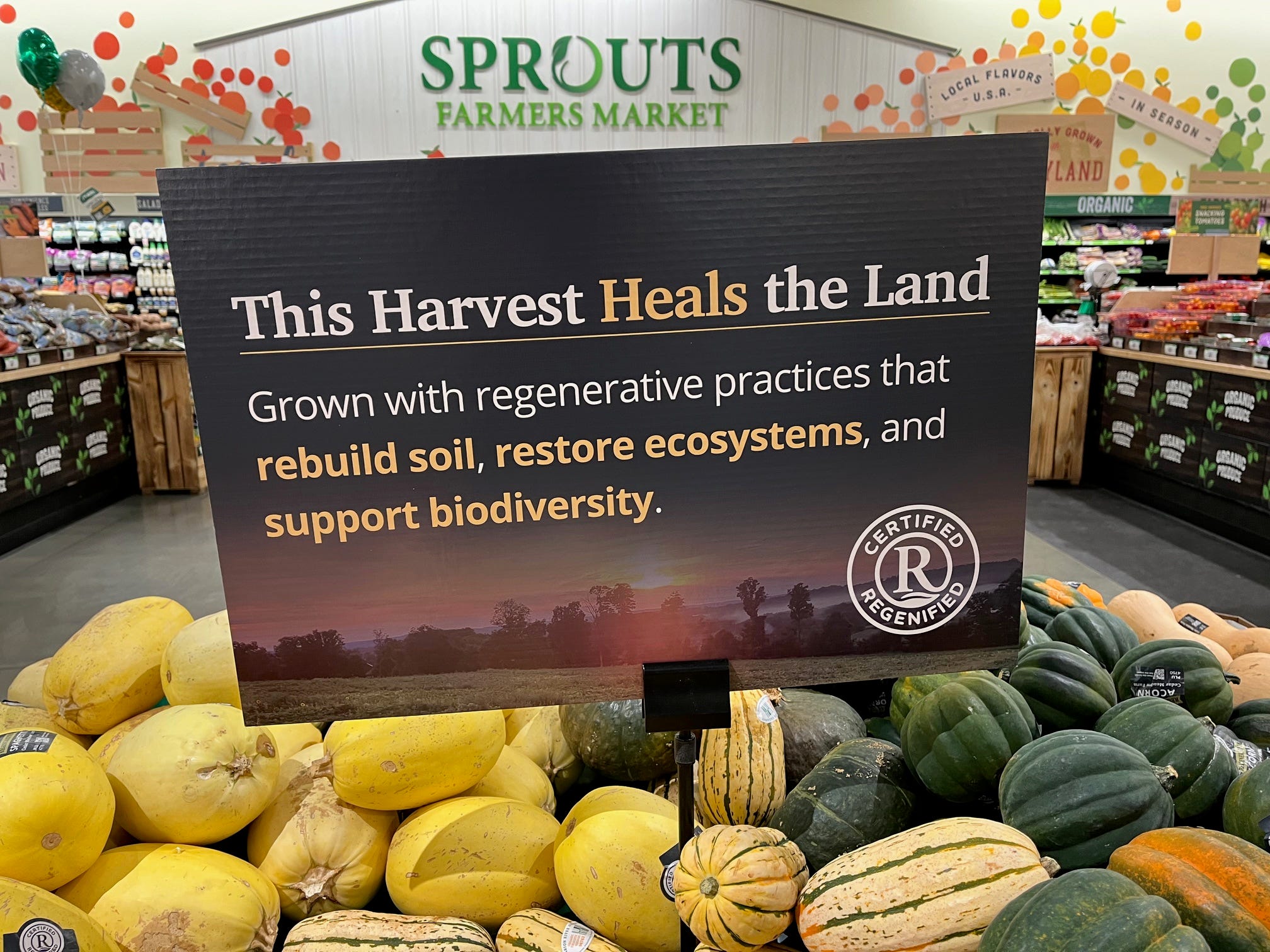 A sign above some squashes reads: