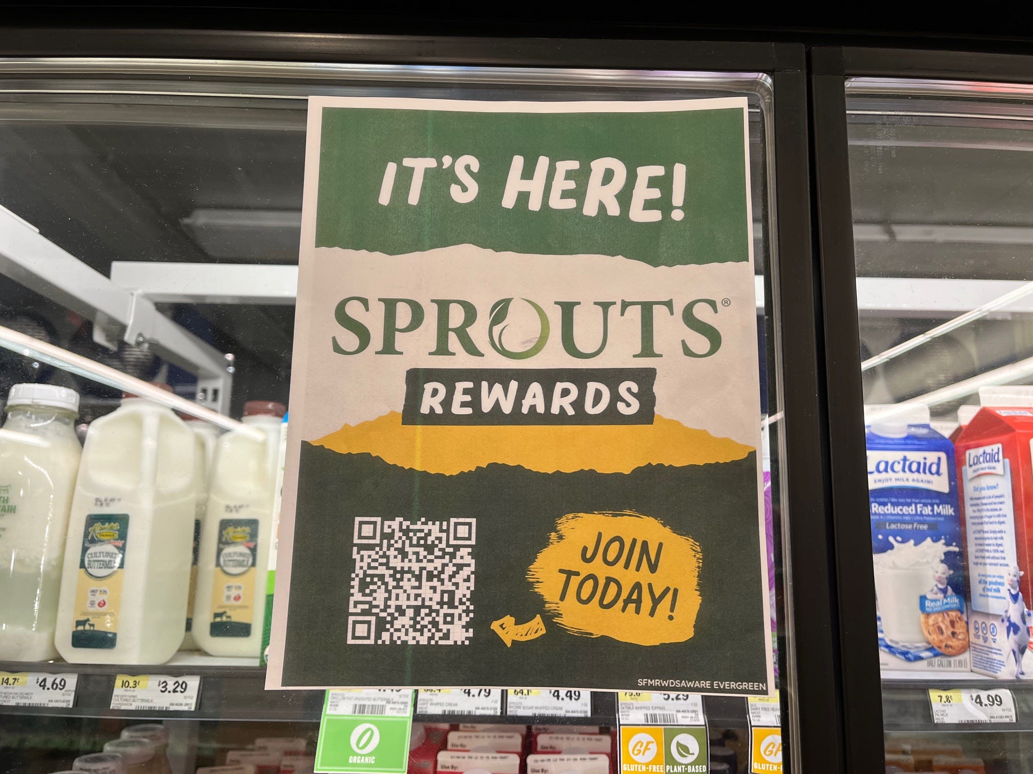 A sign posted on a cooler door reads