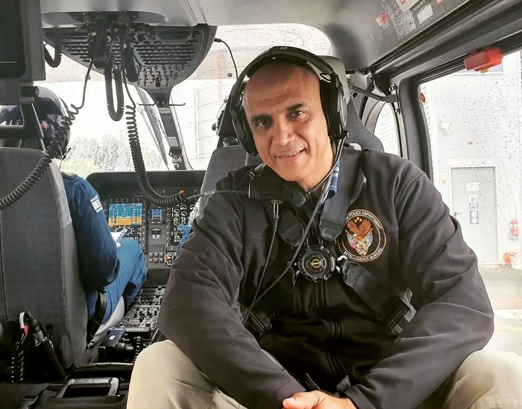 Charlie Benaim, a veteran NYPD detective and foreign liaison stationed in Israel, wearing a headset in a helicopter.