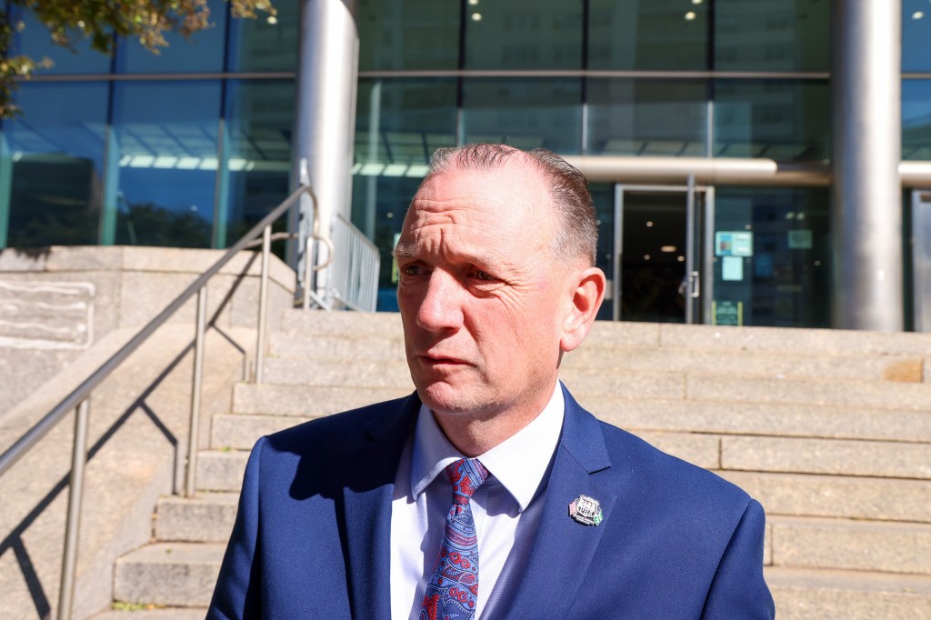 NYC PBA President Patrick Hendry talks outside Queens Criminal Court.