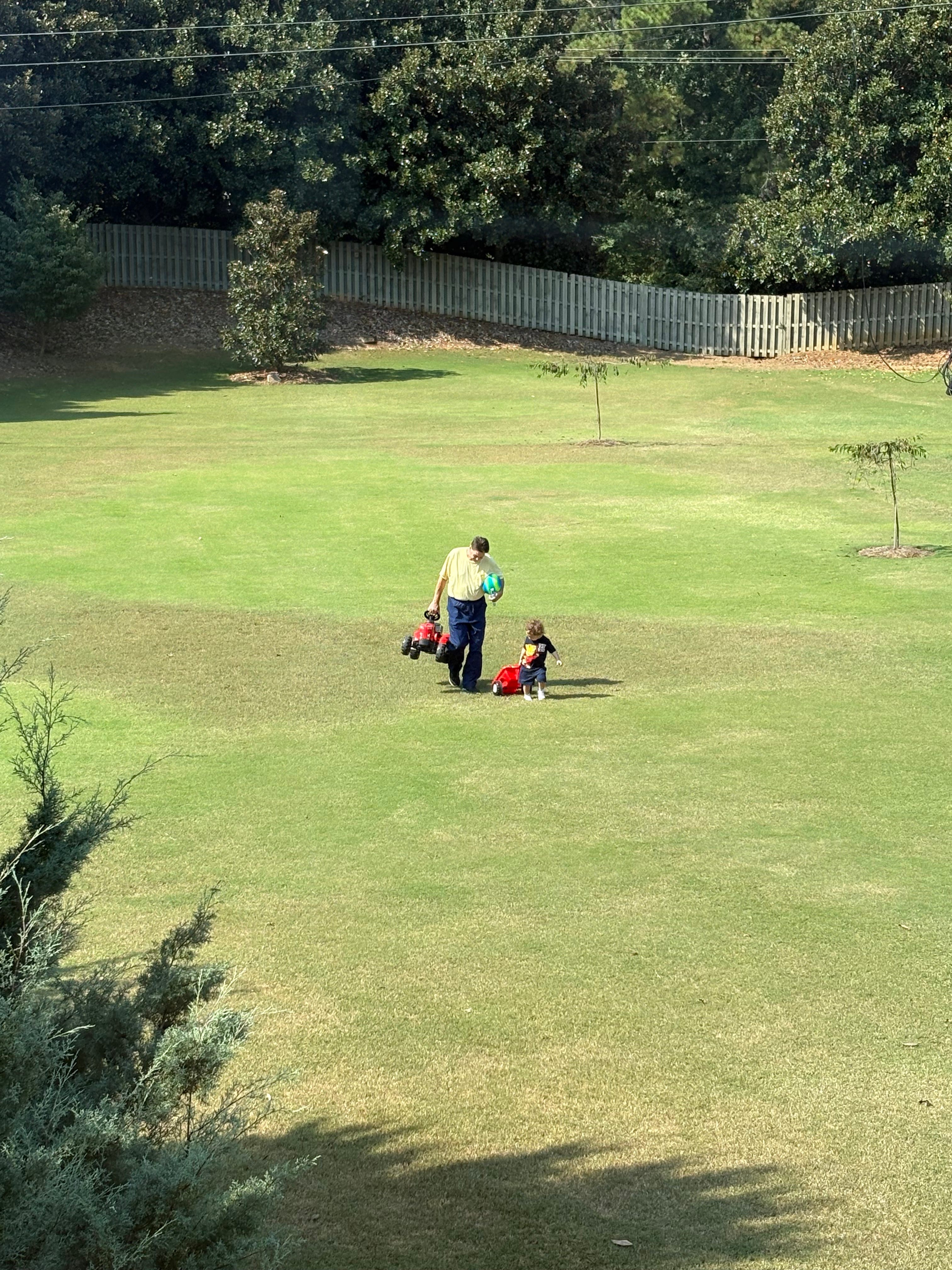 The author's son and grandfather outside in a park.