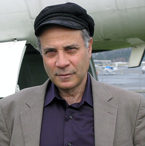 Robert Zubrin in a black hat and purple shirt.