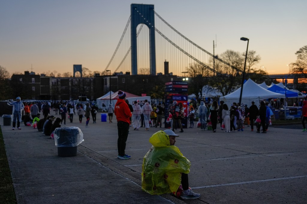 Runners wait near the base of the Verrazzano Narrows Bridge for the start of the New York City Marathon, Sunday, Nov. 2, 2025, in New York.