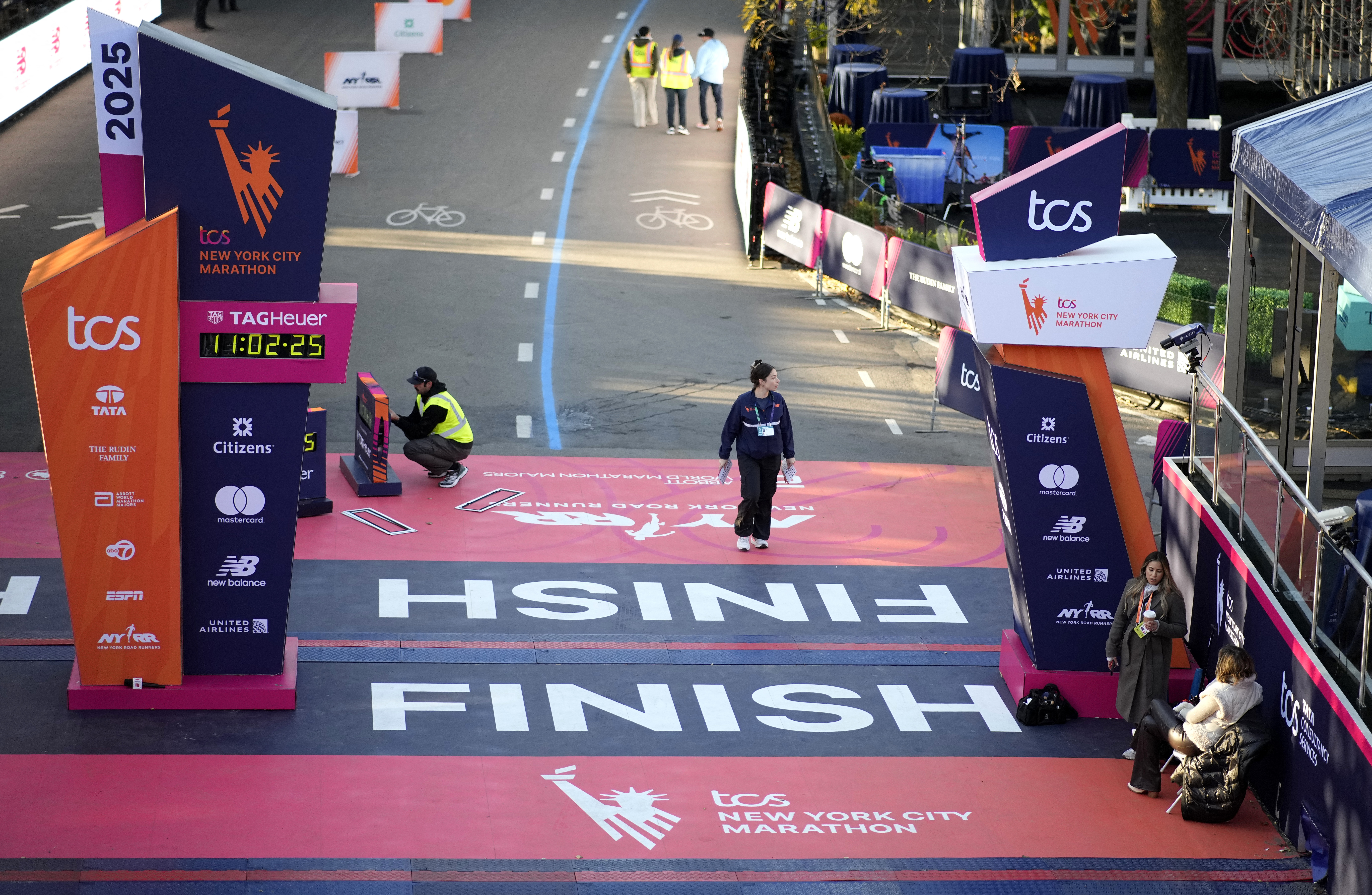 members of staff working on the finish line in Central Park in Manhattan before the marathon 
