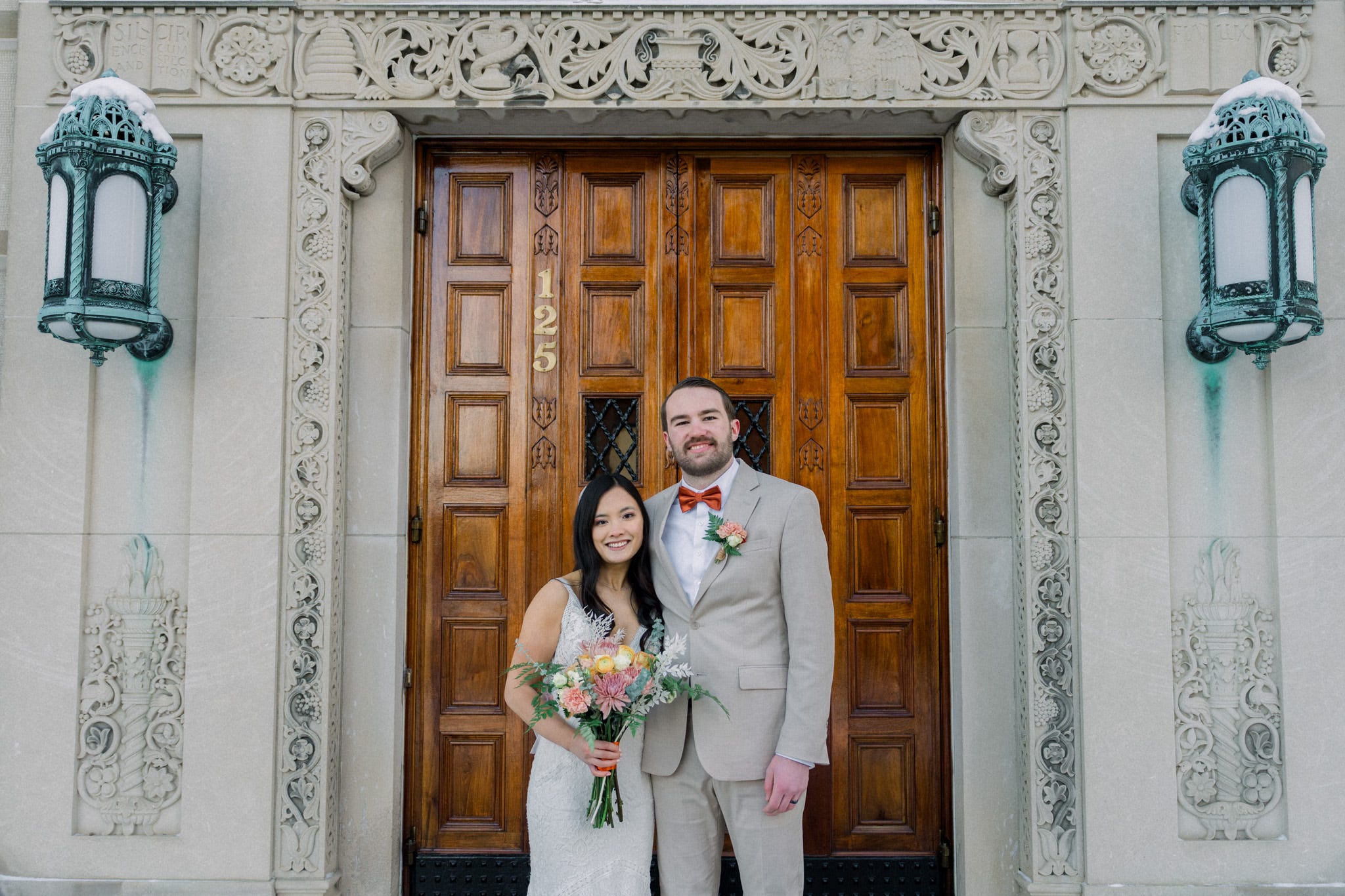 Author Luke Macy in suit with woman in white dress holding flowers