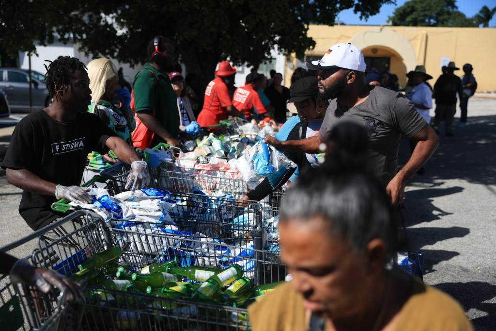 People gather groceries from Curley's House Food Bank days before federal food assistance funding is set to expire.