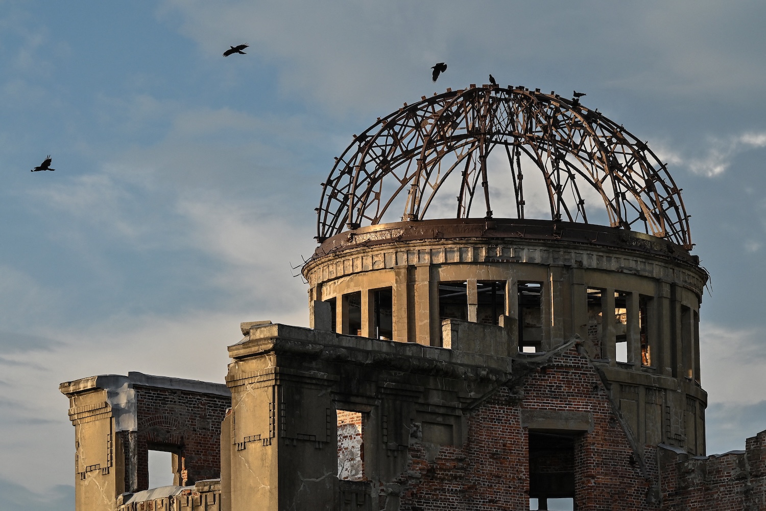 Crows fly around the Atomic Bomb Dome in Japan.