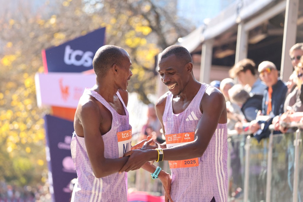 Kenyans Benson Kipruto (right) and Alexander Mutiso celebrate after taking first and second place respectively in the New York Marathon.