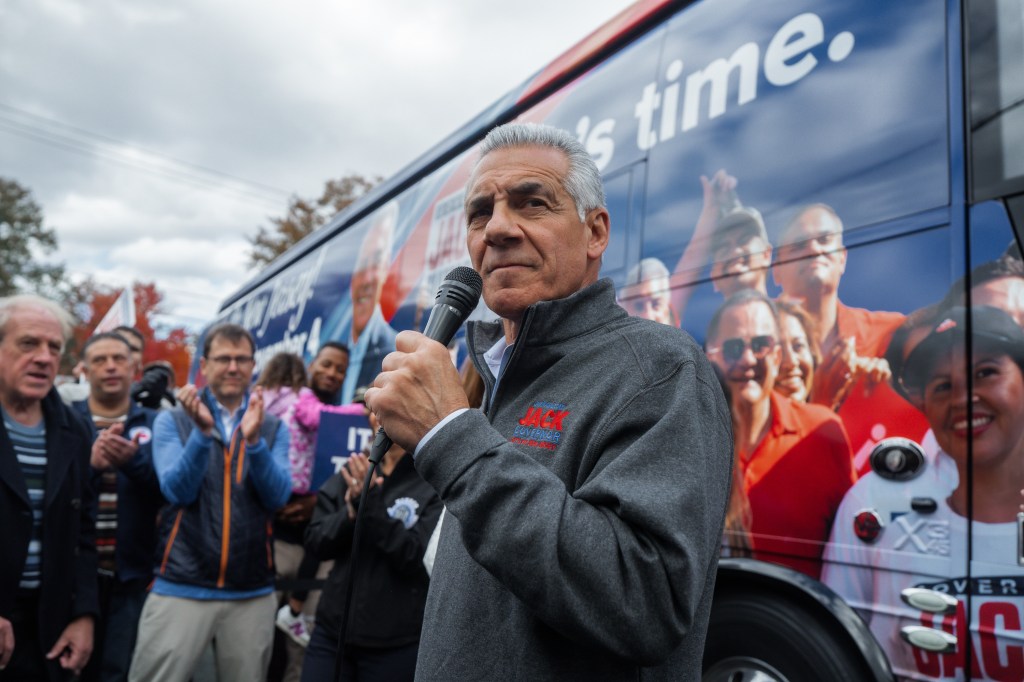 Jack Ciattarelli speaking into a microphone at a campaign rally.