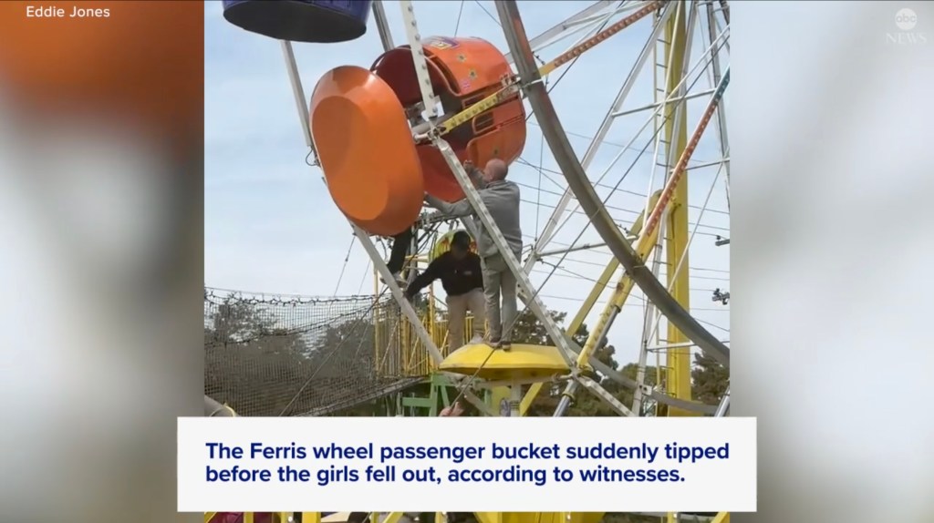 Adults attend to a ferris wheel bucket that has tipped over.