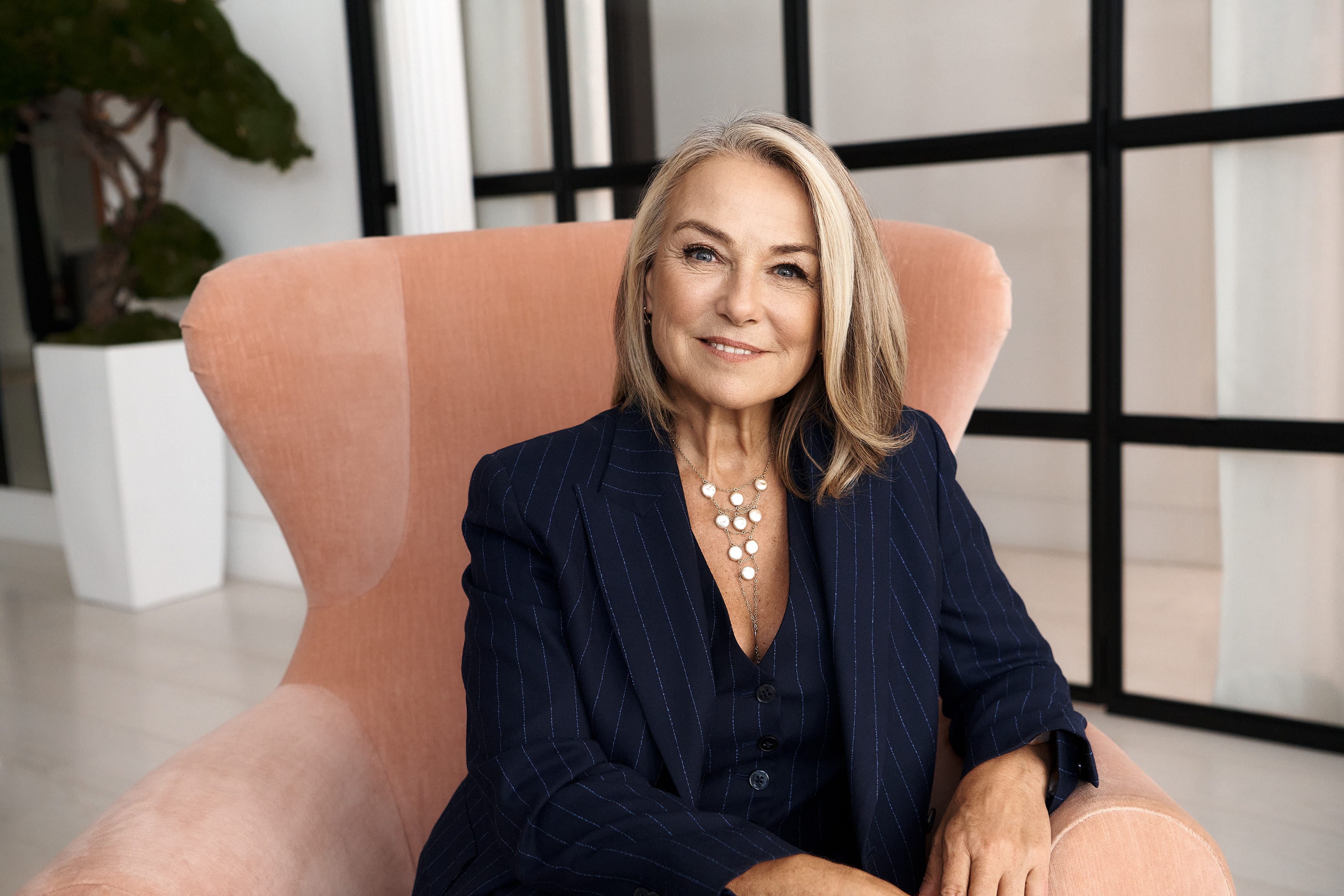 Sex and relationships therapist Esther Perel sitting in a pink chair