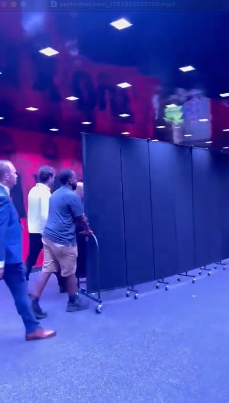 Taylor Swift arriving at a Kansas City Chiefs game behind a screen on wheels.