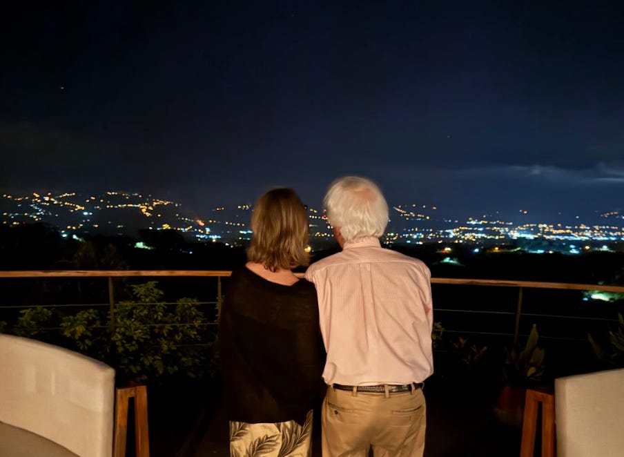 The writer and her husband looking out at the skyline on a trip.