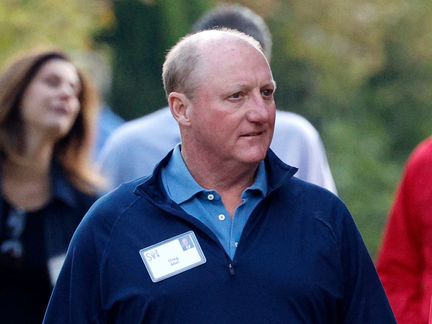 A man and woman walk alongside each down a path looking to the left