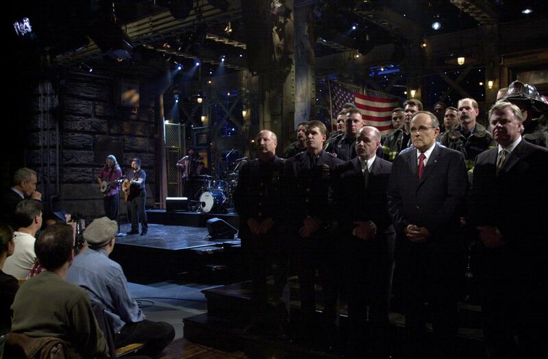 SATURDAY NIGHT LIVE -- Episode 1 -- Air Date 09/29/2001 -- Pictured: SATURDAY NIGHT LIVE -- Episode 1 -- Air Date 09/29/2001 -- Pictured: Paul Simon performs, members of the New York Fire Department, New York Police Department, Port Authority Police Department, with (center, l-r) Police Commissioner Bernard Kerik, Mayor Rudolph Guiliani, Fire Commissioner Tom Von Esses on September 29, 2001  (Photo by Dana Edelson/NBCU Photo Bank/NBCUniversal via Getty Images via Getty Images)