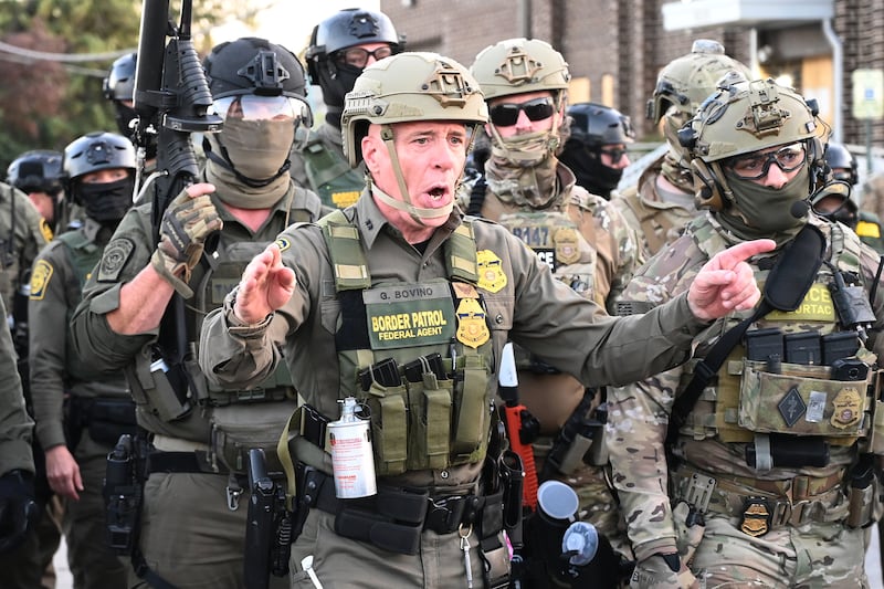 Border Patrol Chief Gregory Bovino of the El Centro Sector stands amid a protest outside an ICE facility in Broadview on Sept. 27, 2025. Bovino, who recently spearheaded controversial immigration crackdowns in Los Angeles and Chicago, faces demonstrators voicing opposition to immigration policies.