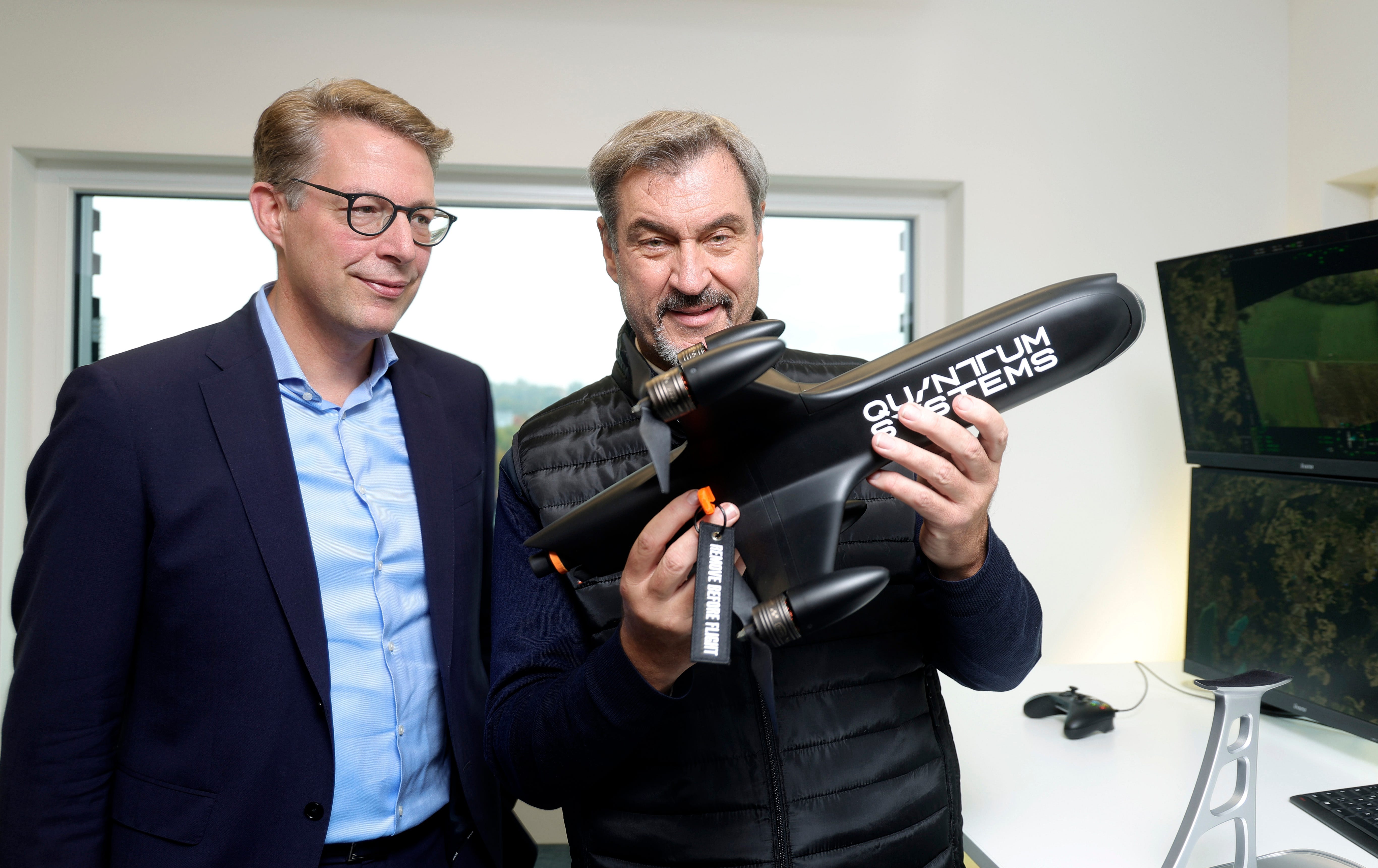 Bavarian officials hold a Quantum Systems Jaeger interceptor drone.