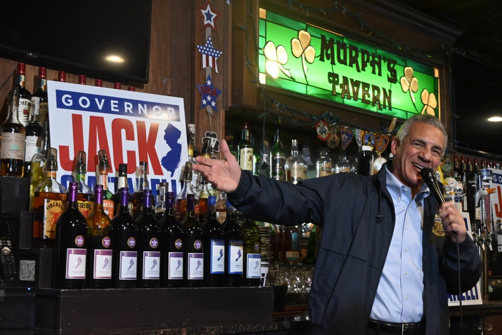 Jack Ciattarelli speaking into a microphone at Murph's Tavern with a