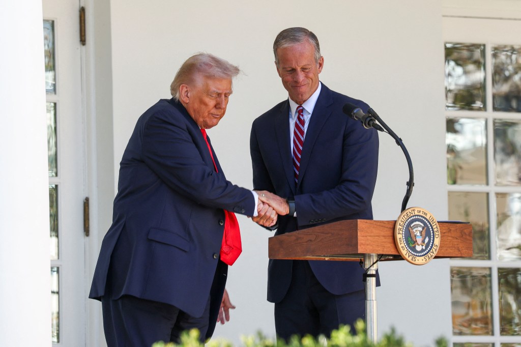 U.S. President Donald Trump shakes hands with U.S. Senate Majority Leader John Thune (R-SD) during a Rose Garden Club lunch at the White House in Washington, D.C., U.S., October 21, 2025.