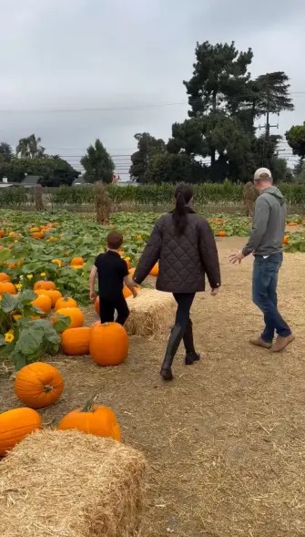 Meghan Markle and Prince Harry with their children at a pumpkin patch.
