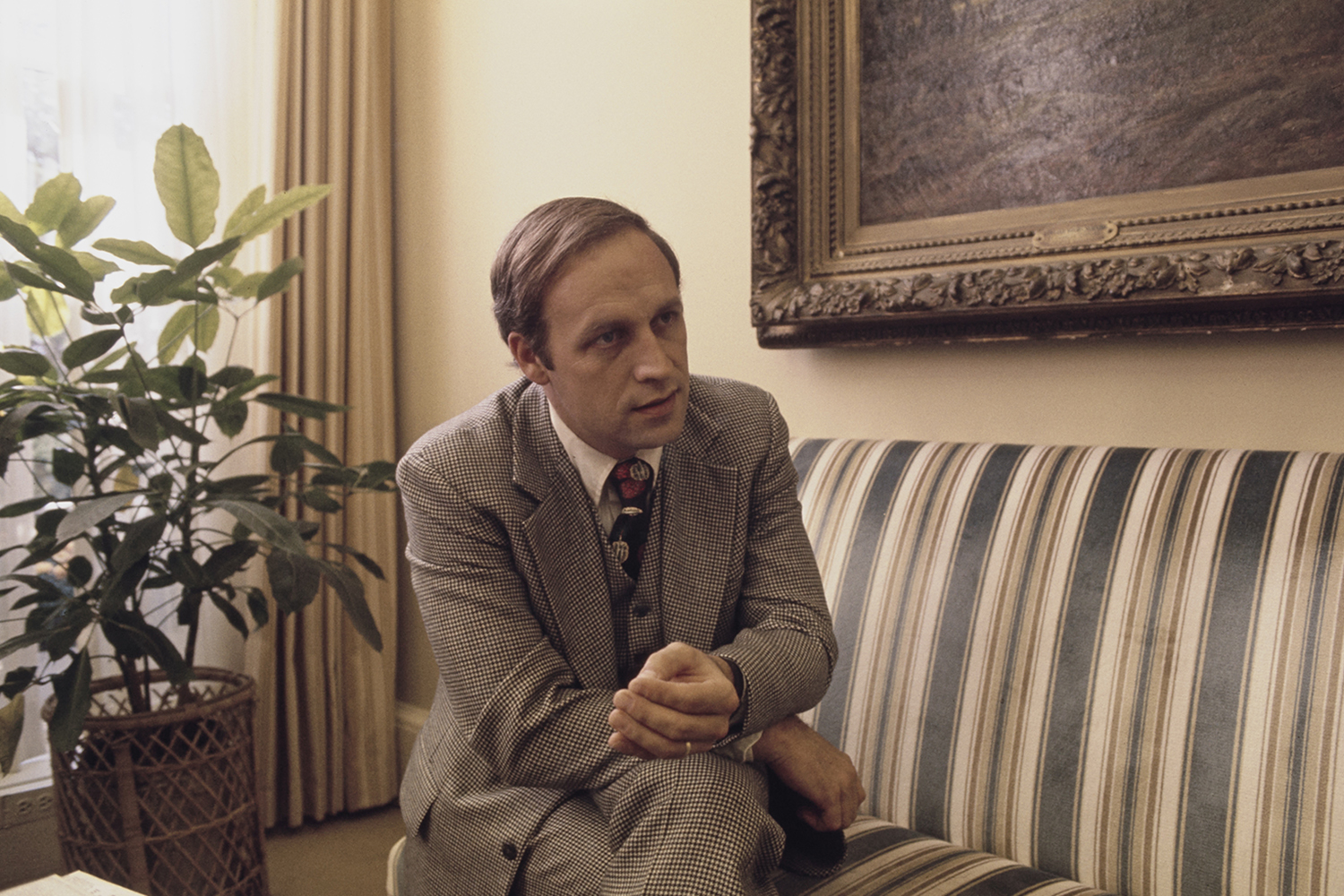 Dick Cheney talks on a couch