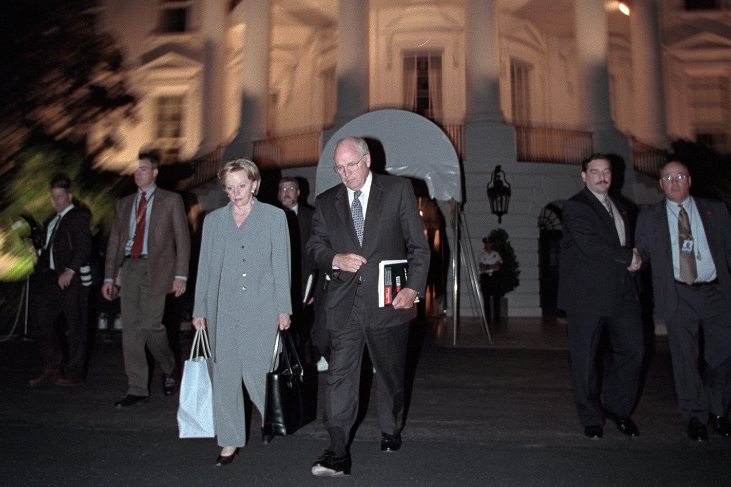 Dick Cheney and Lynne Cheney walk away from the White House.