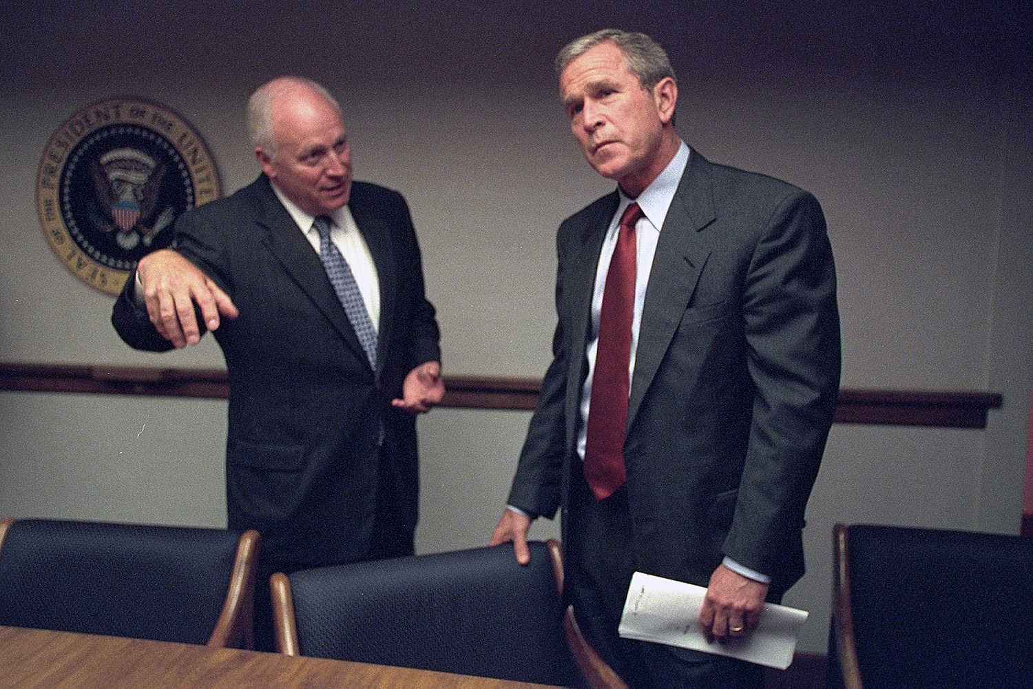 Dick Cheney talks with George W. Bush.
