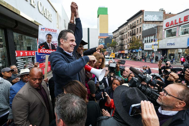 Former New York Governor Andrew Cuomo, independent candidate for New York City mayor, raises his hand with former New York City Council member Ruben Diaz Sr., during a campaign stop in the Washington Heights neighborhood in the Manhattan borough of New York City on November 3, 2025. New Yorkers will pick a new mayor on November 4 after an unpredictable race that has drawn attention from far beyond the largest city in the United States, with President Donald Trump branding frontrunner Zohran Mamdani