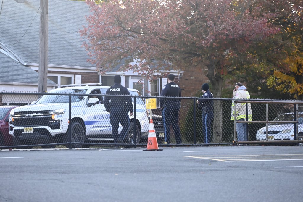 Law enforcement and a firefighter respond to a bomb threat at Columbus Elementary School in Lodi, New Jersey.