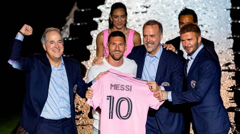 Lionel Messi presents his jersey next to Inter Miami owners, Jorge Mas, far-left, Jose Mas, third from left, and David Beckham, far-right,